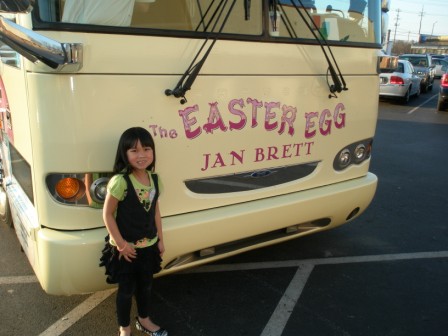 Kasen in front of Jan Brett's bus